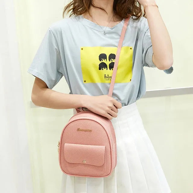 Women's small black PU shoulder backpack with a letter purse and zipper closure.