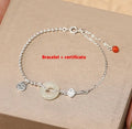 Women's silver bracelet with a geometric Hetian jade Wishful Blessings charm on a white background.