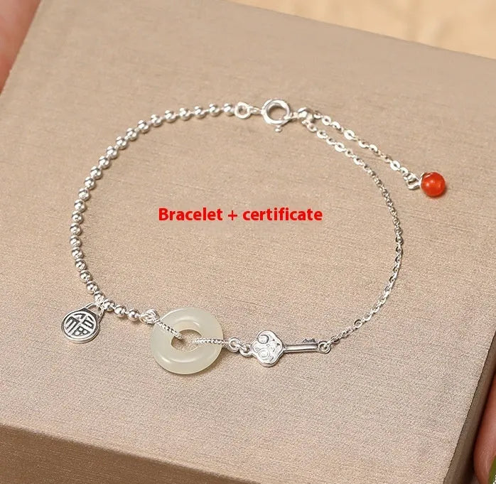 Women's silver bracelet with a geometric Hetian jade Wishful Blessings charm on a white background.