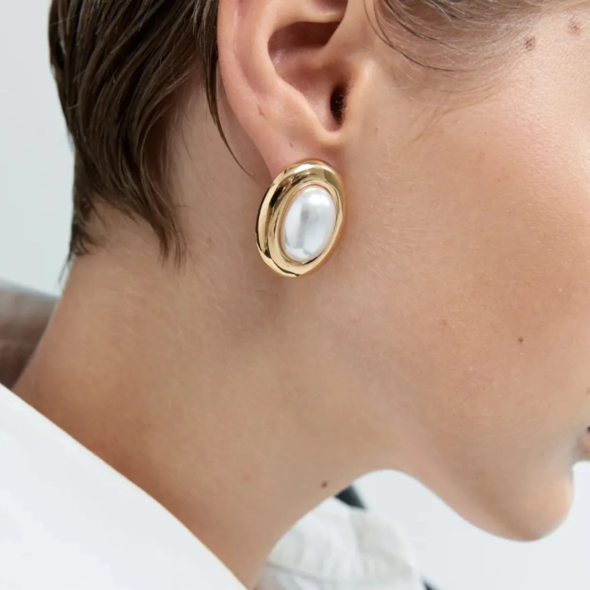 Stainless steel vintage pearl ear studs for women with electroplated finish.