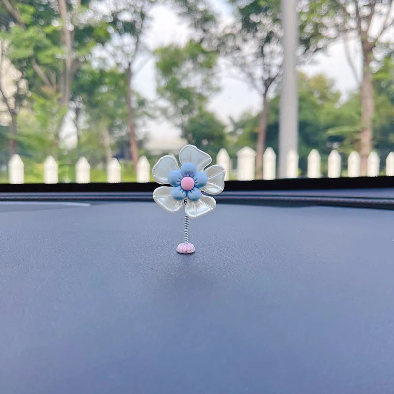 Cute plastic swing car decoration in blue, showing approximate 5cm height.