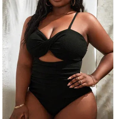 Black plus size one-piece swimsuit for women on a mannequin, showing sleeveless design.