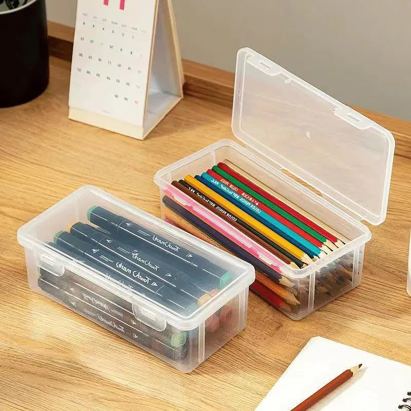 Large clear plastic stationery storage box filled with coloured pencils and crayons