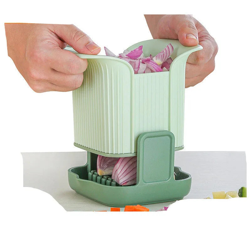 Green manual vegetable chopper with stainless steel cutting grid for slicing onions, potatoes, radishes and cucumbers