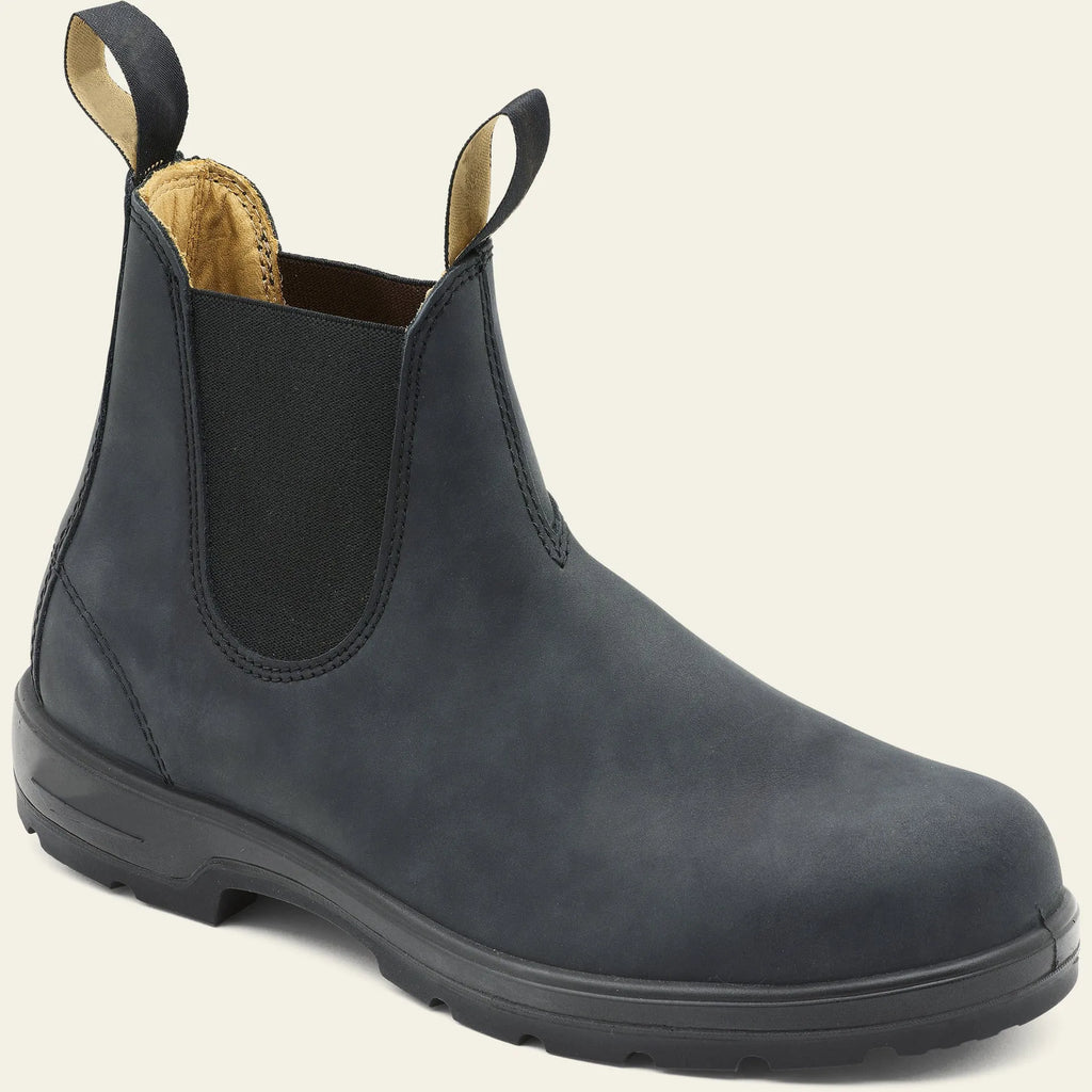 Vintage frosted brown leather Chelsea boots with round toe and car suture detailing on a wooden floor.