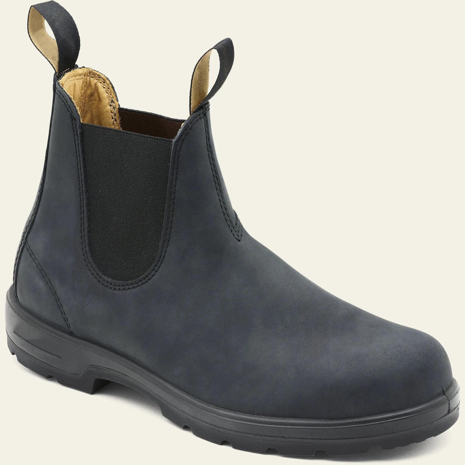 Vintage frosted brown leather Chelsea boots with round toe and car suture detailing on a wooden floor.