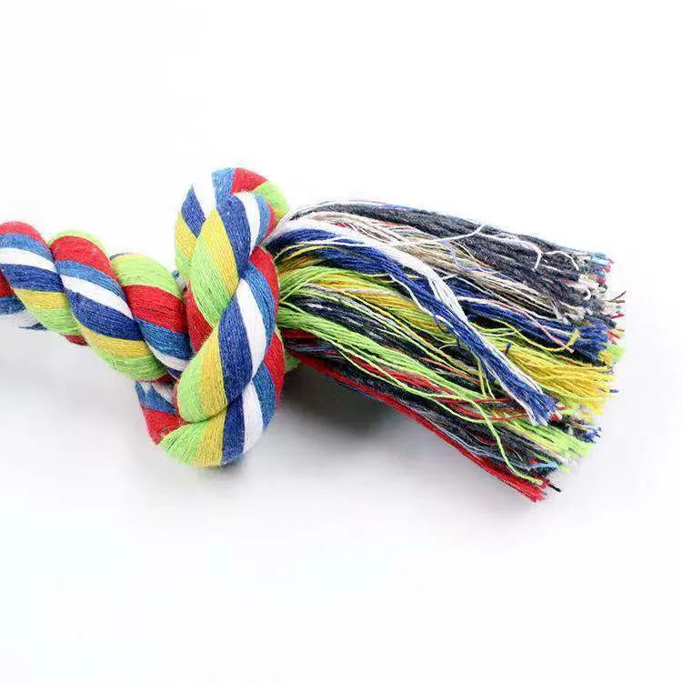 Double knot cotton rope dog toy on neutral background showing two rope knots and loose ends