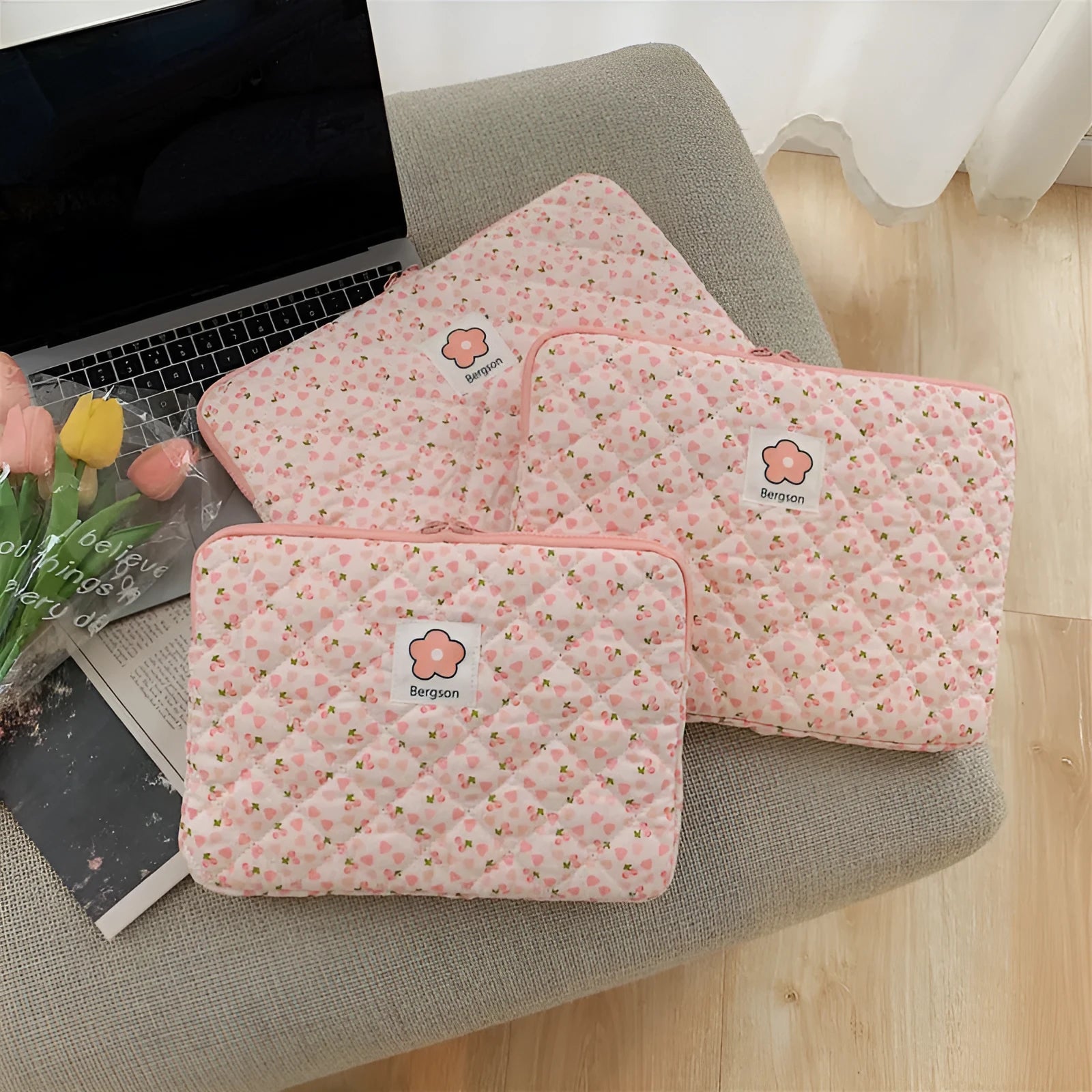 South Korean Ins cotton tablet handbag in green flower pattern with zipper closure on a table