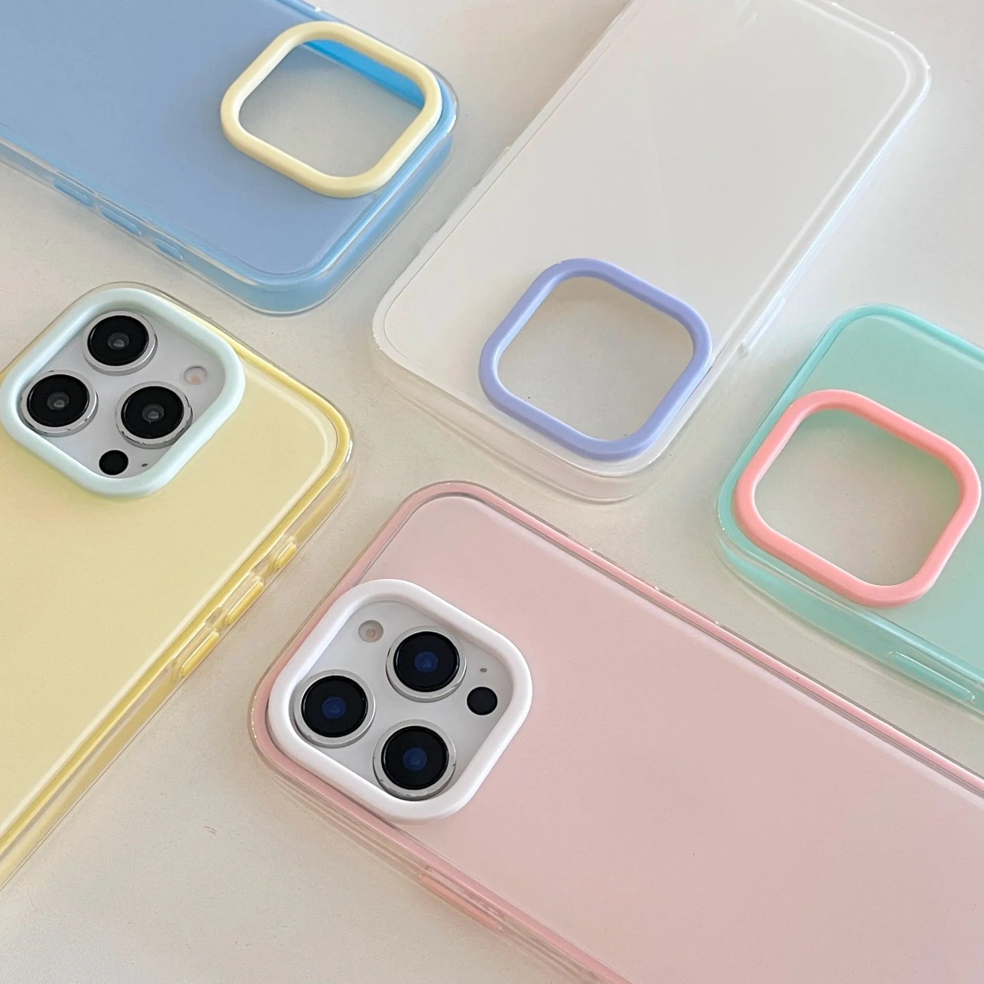 Simple solid colour jelly TPU phone case for iPhone, shown in blue, white, and yellow.