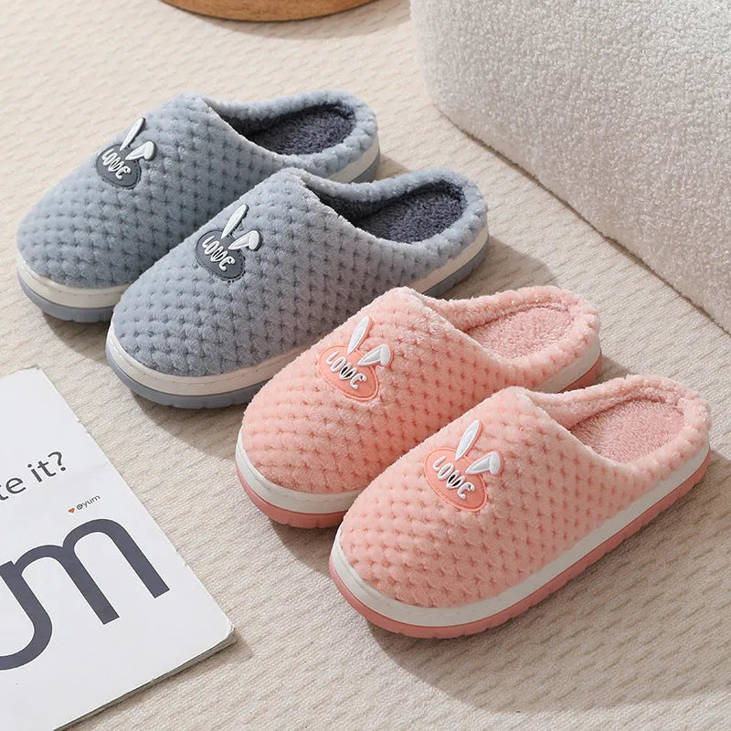 A pair of plush artificial fur house slippers with a baotou toe and a flat rubber sole, shown in a choice of colours.