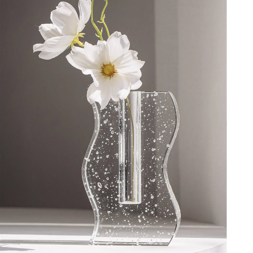 Transparent crystal vase with solidified bubble patterns on a simple modern background