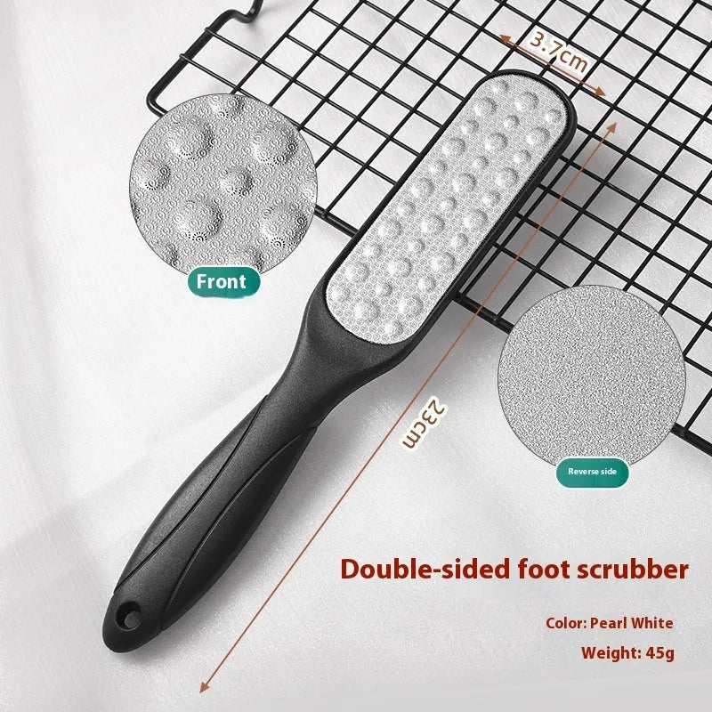 Double-sided stainless steel foot grinder with white and black sandpaper surfaces for callus removal