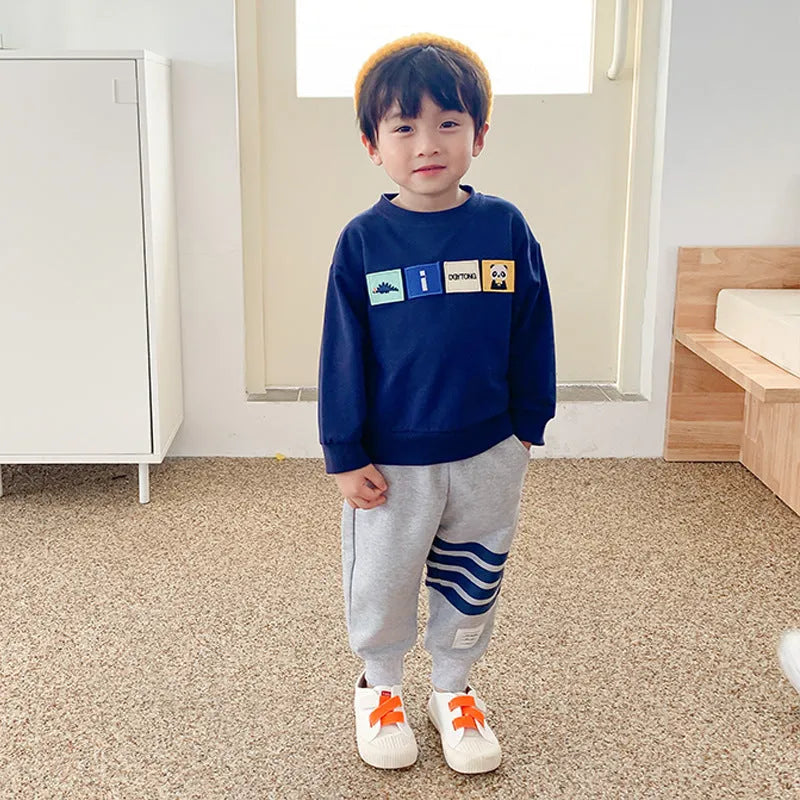 Boys' grey cotton sports trousers with elasticated waistband on child model