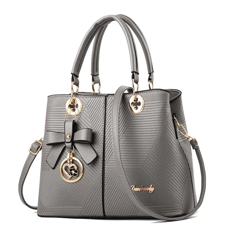 Retro style women's handbag in PU leather with a zipper and adjustable strap in five colour options.