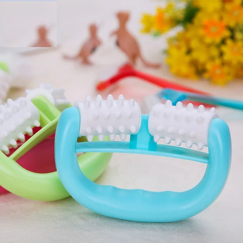 Handheld anti-cellulite massager roller with dot wheels in blue, green, and rose red colours on white background