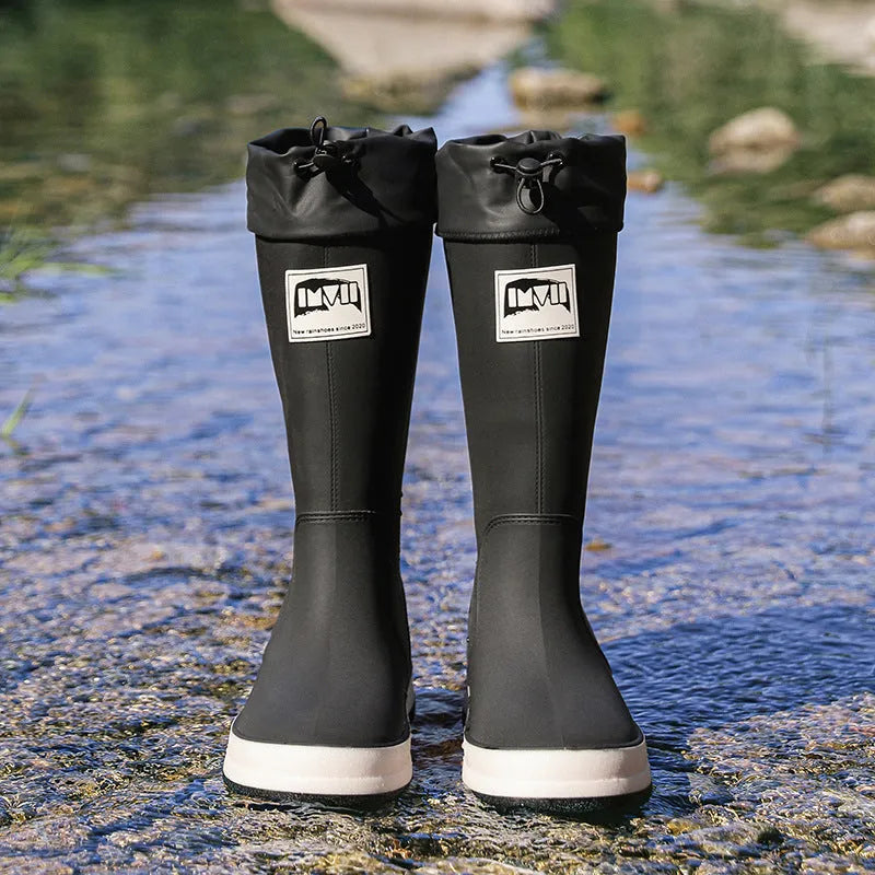 Pair of solid colour high tube PVC rain boots with a low heel on a non-slip sole.