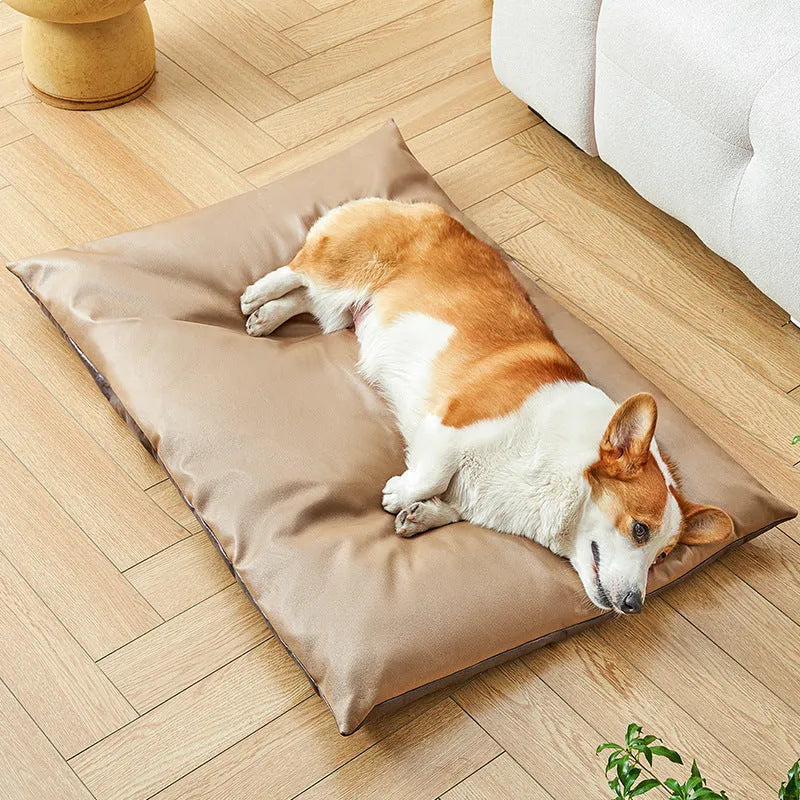Blue plush fabric pet sleeping mat for cats or small dogs shown in a home setting.