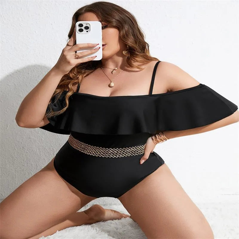 Women's solid black one-piece polyester swimsuit on a hanger