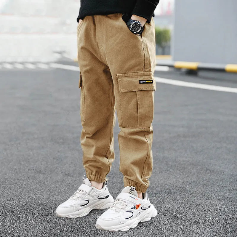 Boys' casual cotton summer trousers in army green, shown flat with size label visible.