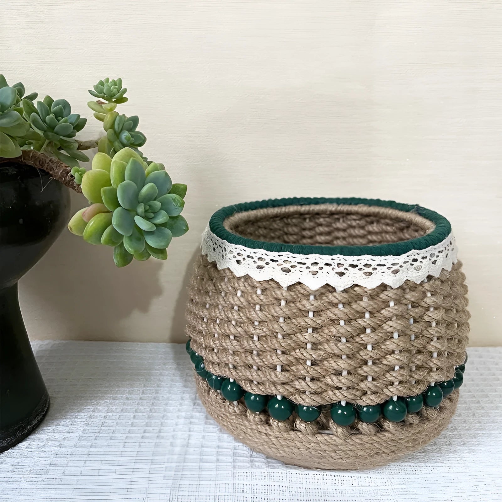 Hand woven rattan cylinder storage basket in solid green on a table, holding snacks and sundries