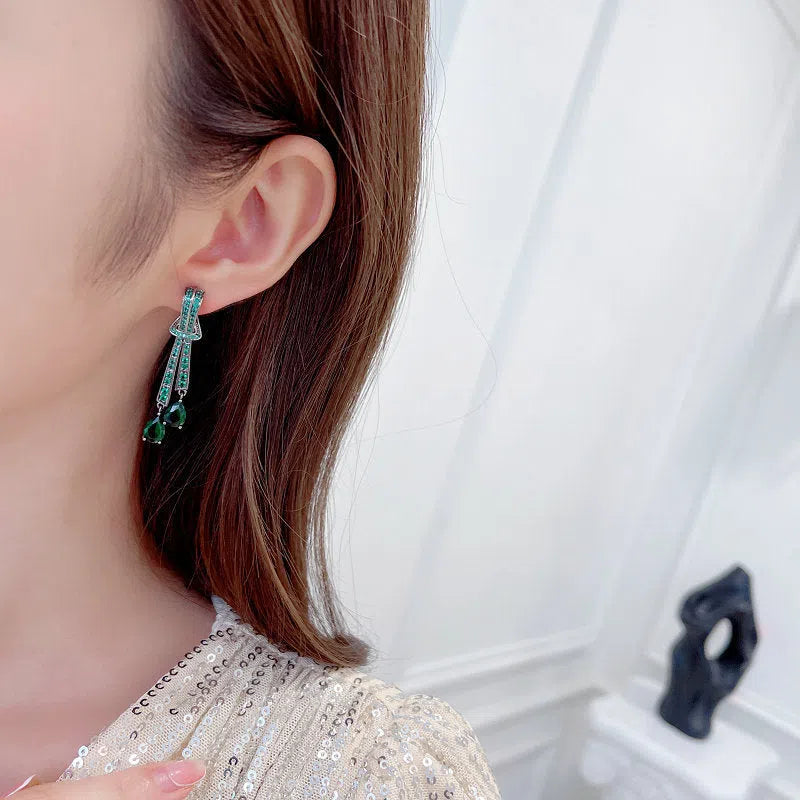 Knot drop earrings with silver needle post and zircon inlay in copper with electroplated finish, gold pearl colour