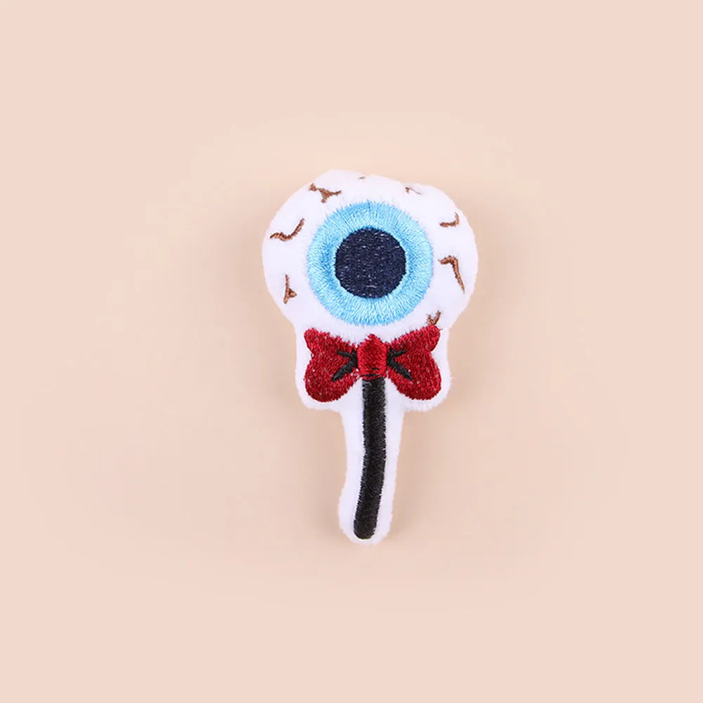 Small handheld cat teaser with plush candy and eyes attachments on wand