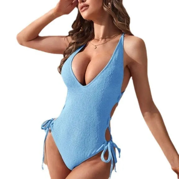 Women's hollow backless tether one-piece swimsuit in a solid colour.
