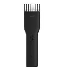 Black and white cordless men's hair clipper with ceramic cutter head and adjustable comb.