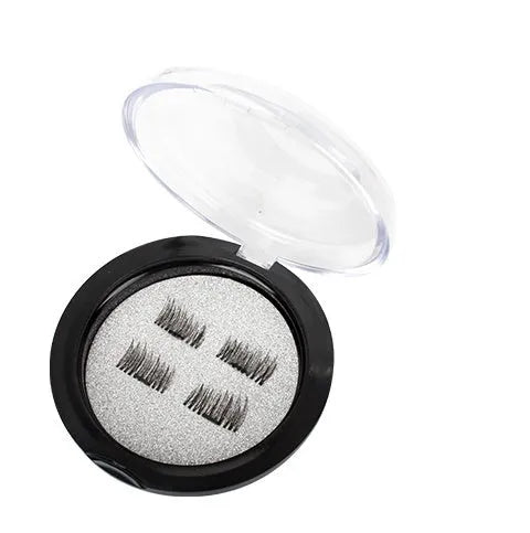 Stainless steel fine mesh tea strainer on a white background with loose tea leaves nearby