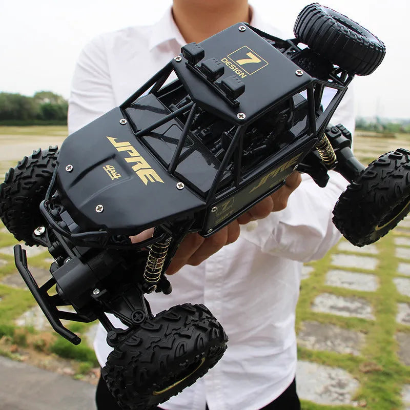 Large black 4WD remote control climbing car and smaller silver high-speed model with 2.4G remote.