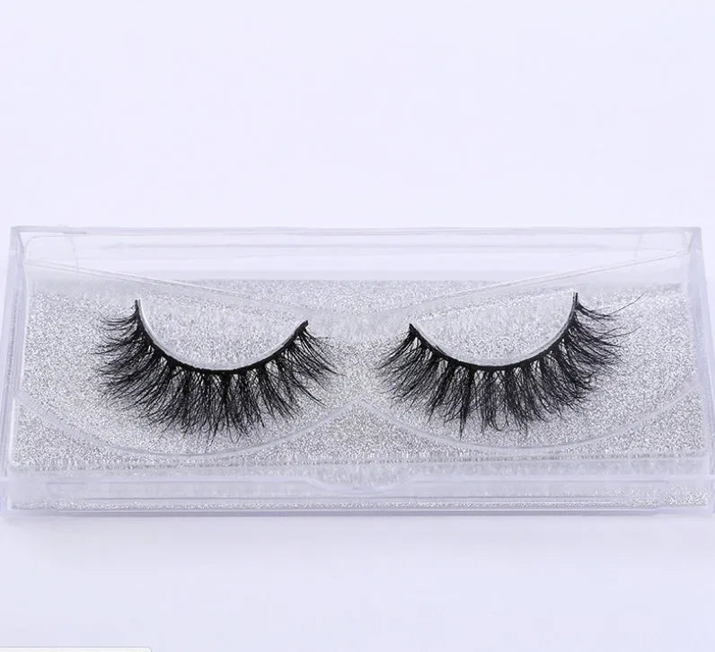 Pair of faux mink eyelashes with long tail and cotton stem against white background