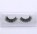 Pair of faux mink eyelashes with long tail and cotton stem against white background