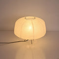Japanese style xuan paper desk lamp on a wooden desk with soft warm light