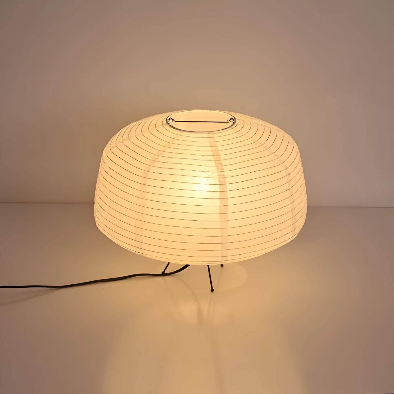 Japanese style xuan paper desk lamp on a wooden desk with soft warm light