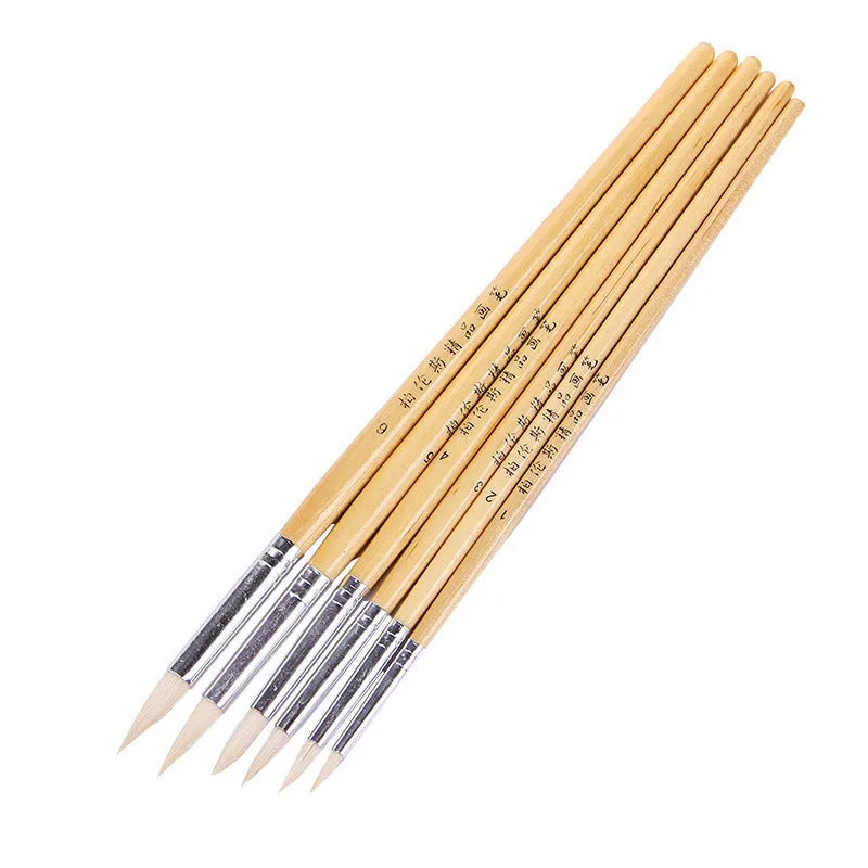 Six wooden hook line pen brushes with wool pointed tips arranged together