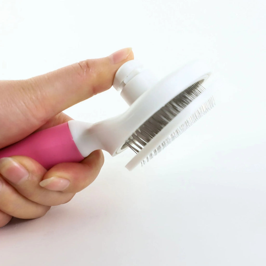 Blue automatic hair removal pet comb with TPR non-slip grip and button shaved design on white background