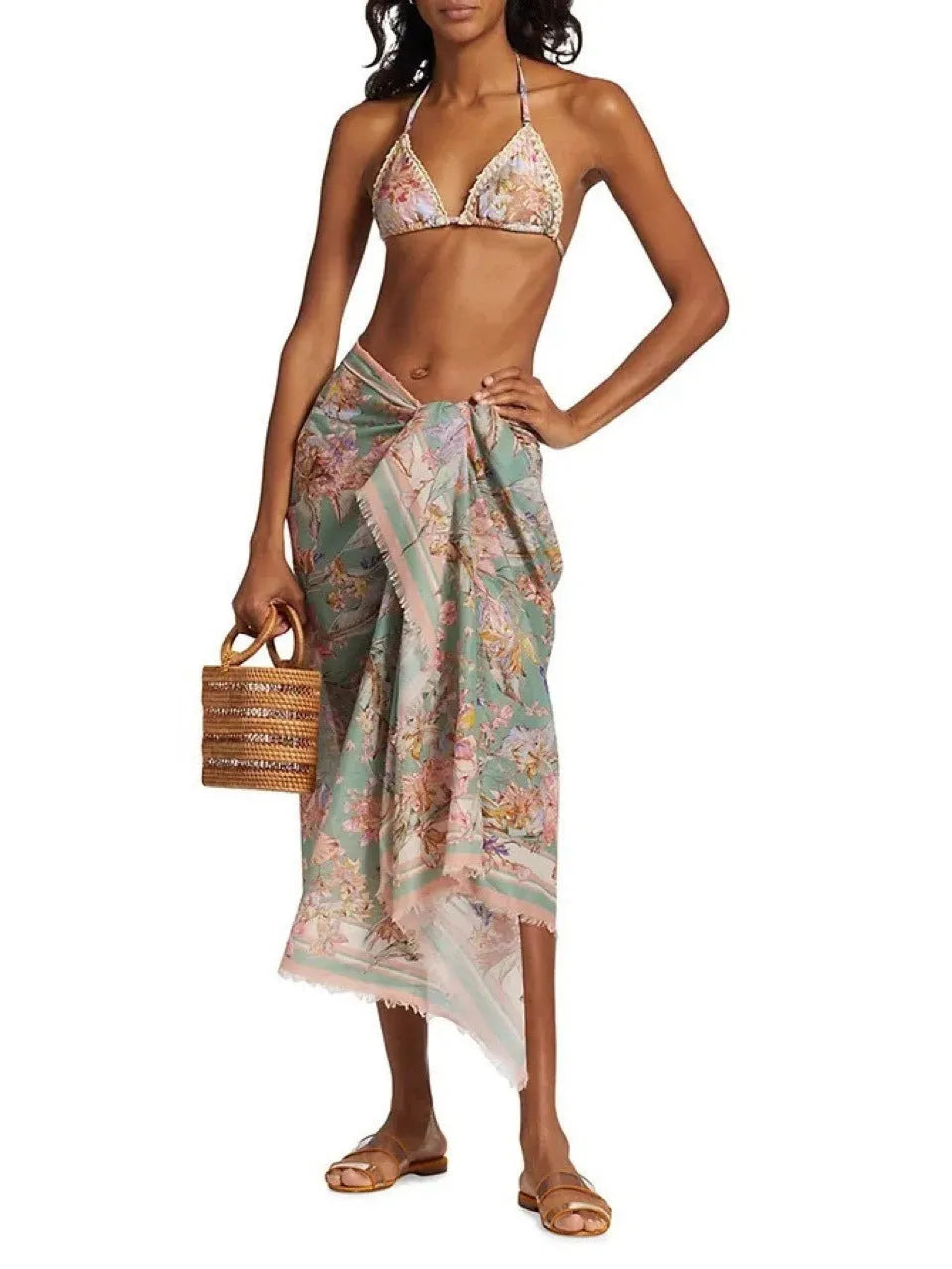 Women's creamy white floral bikini set with halter top, high-waisted briefs and matching skirt