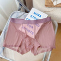 Men's thin grey seamless nylon boxer shorts laid flat, showing mid-waist and body-shaping design.