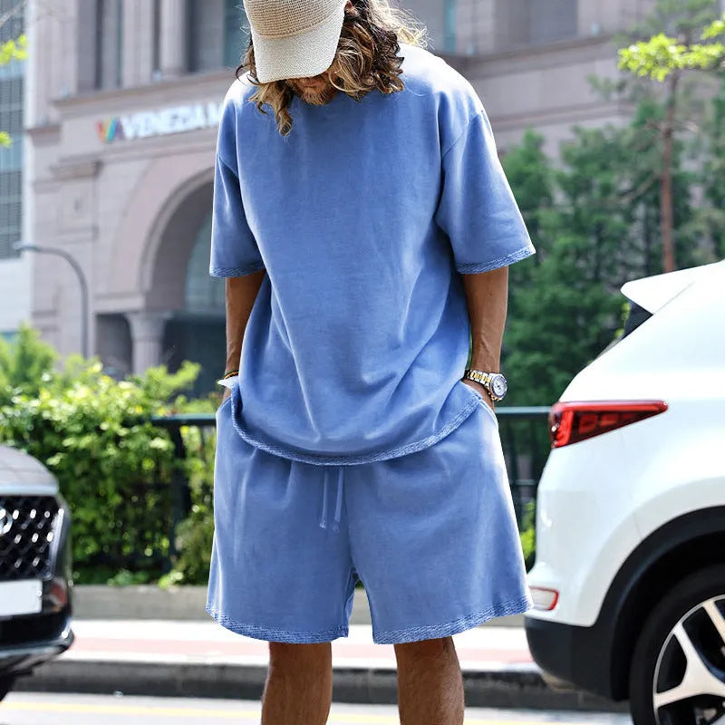 Men's casual sports suit set with grey round neck T-shirt and drawstring shorts on model