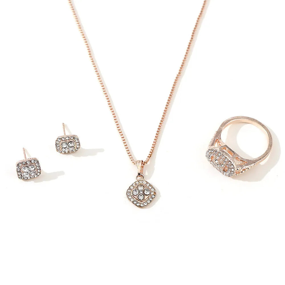 Three-piece alloy rhinestone wedding jewellery set with ring, stud earrings, and necklace in gold finish