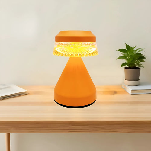 Small black bedside LED lamp with USB charging cable on wooden nightstand