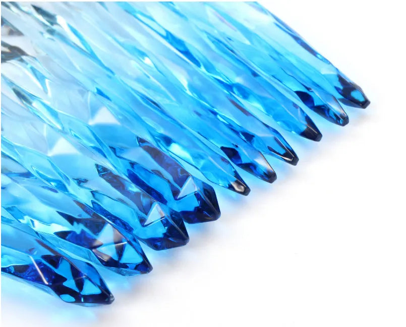 Ten crystal-handle foundation brushes with artificial fibre bristles in a set, showing black, blue, red, and yellow colour options.