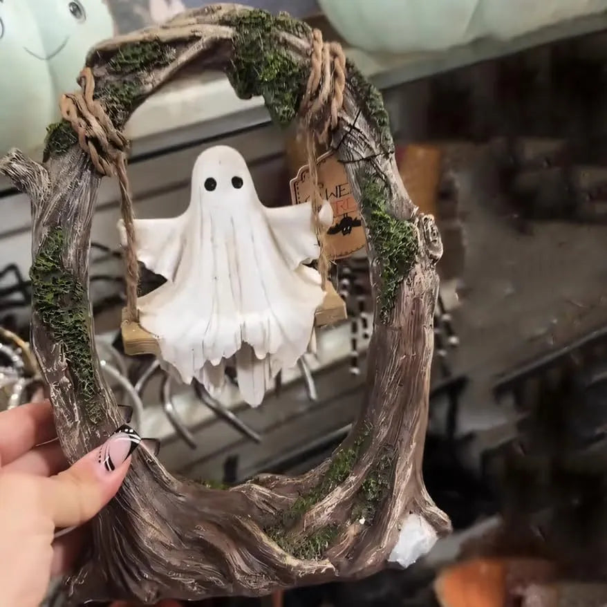 Modern Halloween decoration featuring a stylised white resin ghost on a black swing frame, with two design options shown.