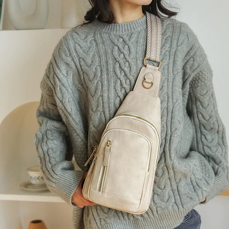 Women's soft PU chest bag in beige colour showing open pocket and crossbody strap