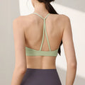 Women's nylon sports vest with fixed double-shoulder straps on a hanger