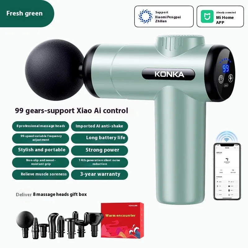 Konka professional electric mini massage gun in grey with multiple massage heads on a table
