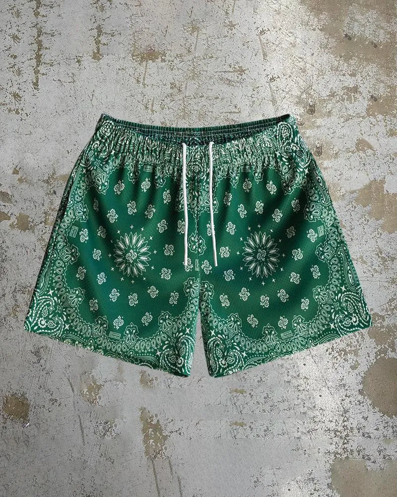 Man wearing loose-fitting digital print beach shorts made from quick-drying milk silk polyester.