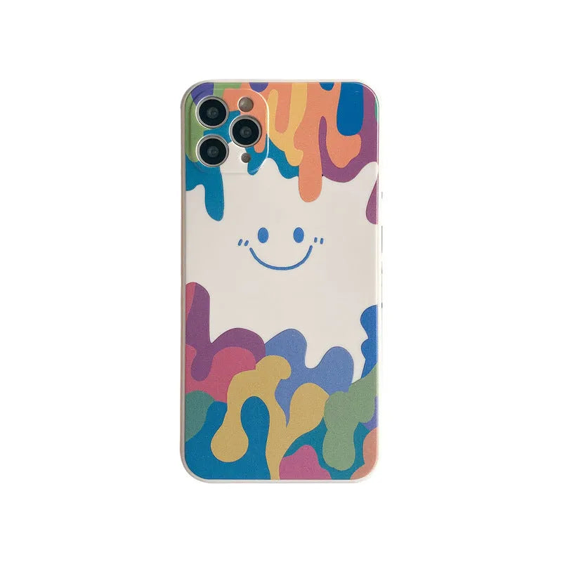 Simple TPU silicone iPhone case with painted smiley face and graffiti design on a table