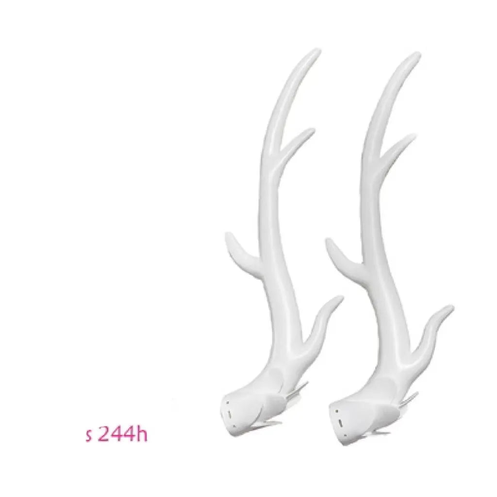 A pair of resin dragon horn decorations for motorcycle helmets in black, shown next to a ruler for scale.