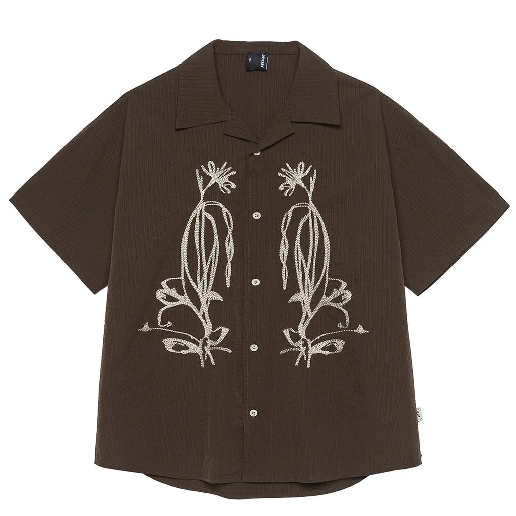 Brown striped outdoor short sleeve shirt with Cuban collar on a hanger.